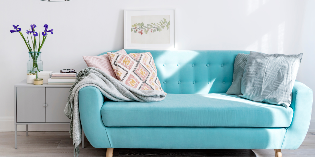 Teal Sofa with pink pillows